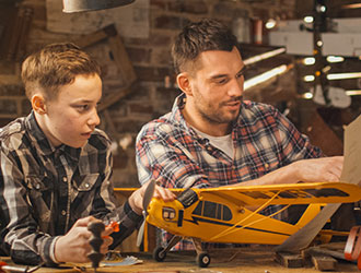 father and son working on a model airplane